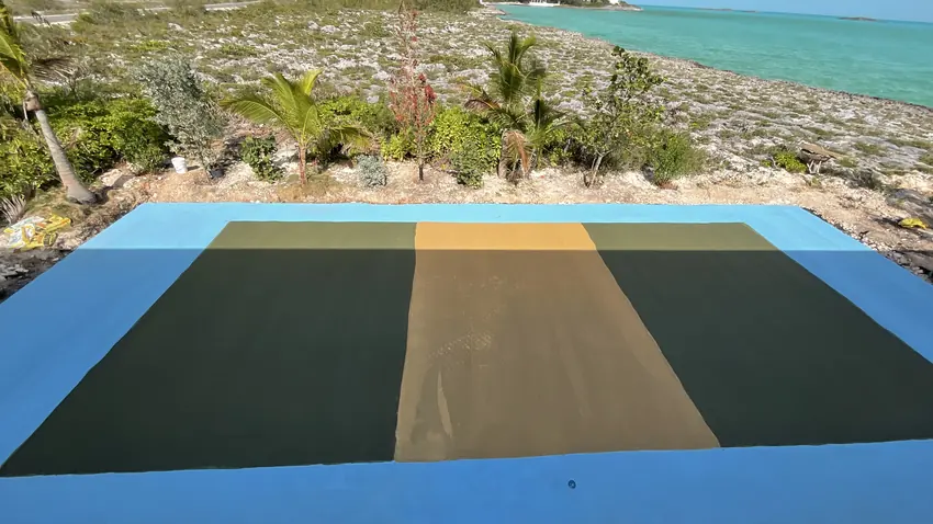 Finished court surfaced in blue, olive and sand beside the water