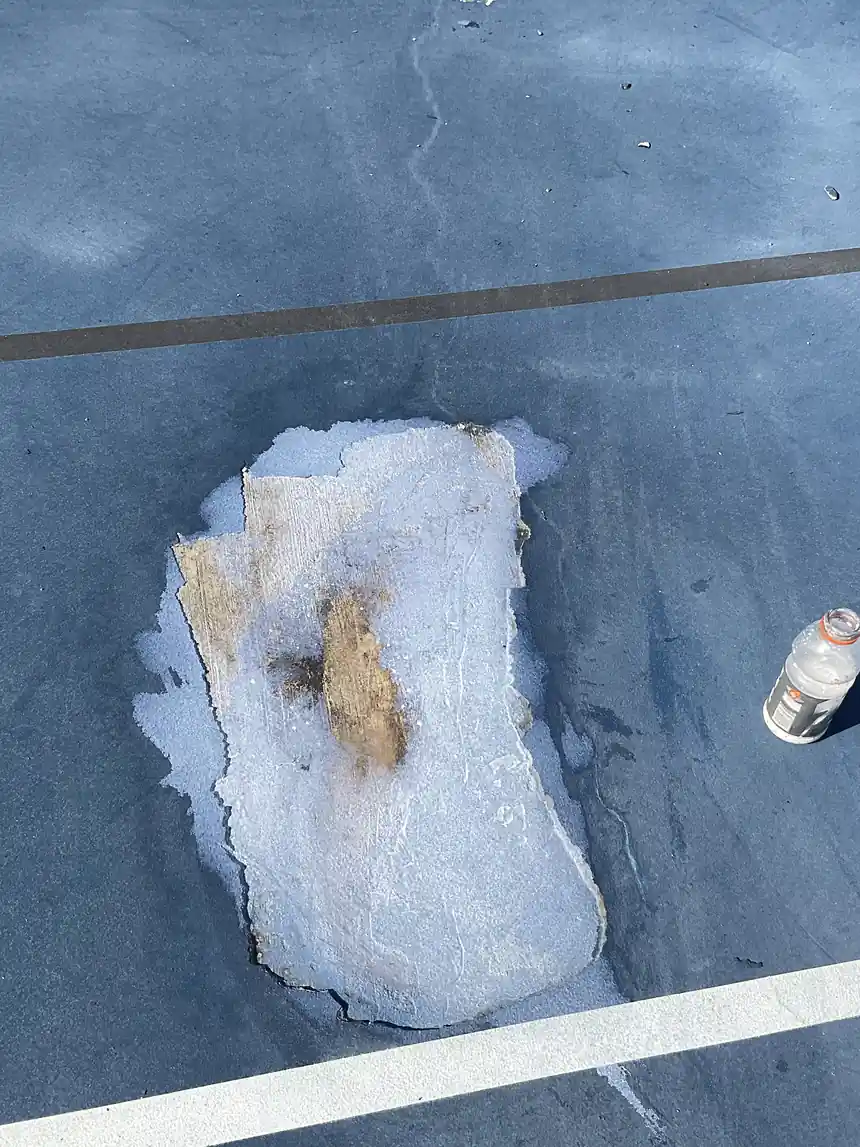 Playing surface coating peeled away in a single sheet, exposing the layer beneath