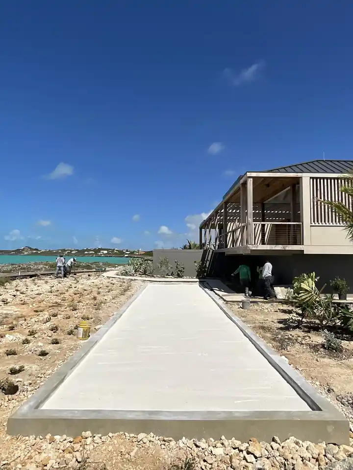 Long concrete bocce court run cast on site with the ocean beyond it