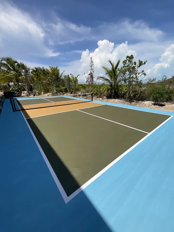 Completed pickleball court in blue, olive and sand with the line set out