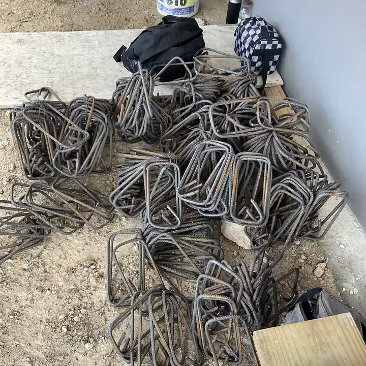 Bent steel stirrups stacked on site before the footings are cast